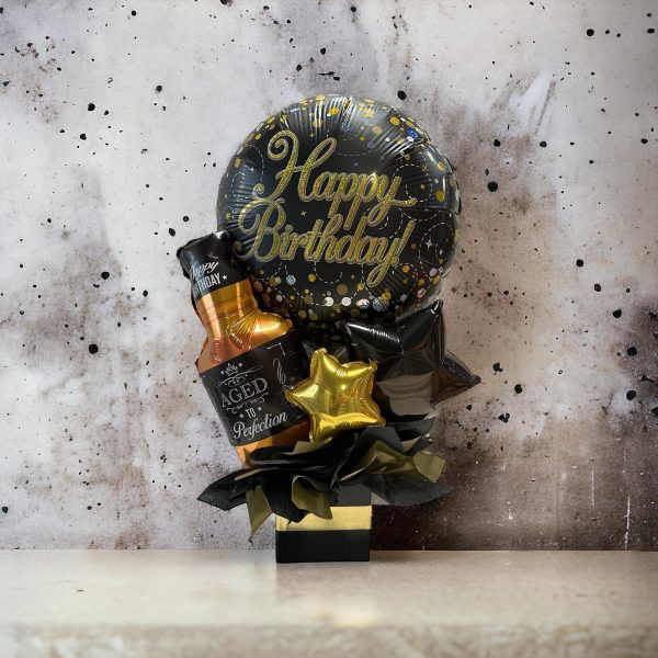 Black and Gold Birthday Gift Balloon Arrangement with Aged To Perfection Whiskey Foil Balloon and Stars in a Black Bok with Gold Ribbon